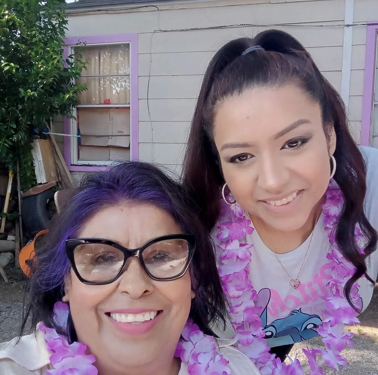 Maria and her daughter together at her granddaughter's birthday party, smiling.